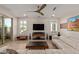 Bright living room featuring a sleek sofa, modern entertainment center, and ample natural light at 3942 N San Marin Dr, Florence, AZ 85132