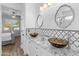 Elegant bathroom featuring dual vessel sinks, granite counters, and a decorative tile backsplash at 39526 N White Tail Ln, Anthem, AZ 85086