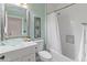 Bright bathroom featuring a vessel sink, turquoise accents, and a combination tub and shower at 39526 N White Tail Ln, Anthem, AZ 85086