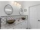 Bathroom featuring dual sinks with vessel basins, granite countertops, and framed mirrors at 39526 N White Tail Ln, Anthem, AZ 85086