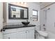 Contemporary bathroom with a dark sink, white cabinets, and a combination tub and shower at 39526 N White Tail Ln, Anthem, AZ 85086