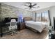 Comfortable bedroom featuring wood accent wall and light neutral colors at 39526 N White Tail Ln, Anthem, AZ 85086