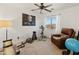 Bonus room with a ceiling fan, a weight rack, and a reading chair at 39526 N White Tail Ln, Anthem, AZ 85086