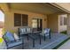 Relaxing covered patio with stylish outdoor seating overlooking the sparkling pool at 39526 N White Tail Ln, Anthem, AZ 85086