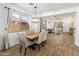 Open dining area with wood-look floors, modern chandelier, and views to the outdoor area at 39526 N White Tail Ln, Anthem, AZ 85086