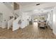 Bright living room featuring an open floor plan flowing into the dining area at 39526 N White Tail Ln, Anthem, AZ 85086