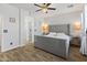 Cozy main bedroom featuring a gray upholstered headboard and ensuite bathroom at 39526 N White Tail Ln, Anthem, AZ 85086