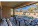 Covered patio with stylish outdoor seating and a view of the pool at 39526 N White Tail Ln, Anthem, AZ 85086