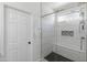 Modern bathroom shower with sleek tile, a glass enclosure, and a built-in bench at 39526 N White Tail Ln, Anthem, AZ 85086