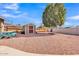 Spacious backyard with a picnic table, shed, large tree, and low-maintenance gravel at 4201 W Brown St, Phoenix, AZ 85051