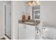 A vanity with granite countertops, white cabinets, and a modern faucet in this bathroom at 4201 W Brown St, Phoenix, AZ 85051