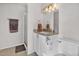 A vanity with granite countertops, white cabinets, and a modern faucet in this bathroom at 4201 W Brown St, Phoenix, AZ 85051