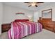 Bedroom with comfortable bed, wood dresser, and neutral colored walls at 4201 W Brown St, Phoenix, AZ 85051