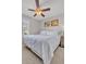 Bedroom with a ceiling fan, large window, and a comfortable bed with white bedding at 4201 W Brown St, Phoenix, AZ 85051