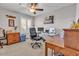 Bright bedroom with a ceiling fan, large window with plantation shutters, and office setup at 4201 W Brown St, Phoenix, AZ 85051