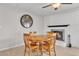 Cozy dining area features a brick fireplace and a wooden table set for intimate gatherings at 4201 W Brown St, Phoenix, AZ 85051