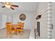 Cozy dining room featuring wood table, chairs, ceiling fan, and brick fireplace at 4201 W Brown St, Phoenix, AZ 85051