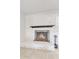 Bright interior shot shows brick fireplace and black fire tools at 4201 W Brown St, Phoenix, AZ 85051