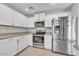 Well-equipped kitchen with stainless steel appliances and white cabinetry, offering convenience for everyday cooking at 4201 W Brown St, Phoenix, AZ 85051