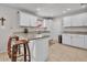 Bright kitchen with white cabinetry, granite countertops, and a cozy breakfast bar island seating at 4201 W Brown St, Phoenix, AZ 85051