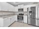 Updated kitchen featuring white cabinets, stainless steel appliances, and granite countertops at 4201 W Brown St, Phoenix, AZ 85051