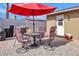 Cozy backyard patio setup with an umbrella and seating area perfect for relaxation at 4201 W Brown St, Phoenix, AZ 85051