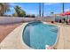 Refreshing backyard swimming pool surrounded by desert landscaping, perfect for hot days at 4201 W Brown St, Phoenix, AZ 85051