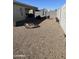 Gravel backyard featuring patio furniture and privacy wall at 45322 W Sandhill Rd, Maricopa, AZ 85139