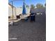 View of a gravel backyard with patio furniture and an umbrella at 45322 W Sandhill Rd, Maricopa, AZ 85139