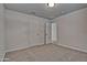 Empty carpeted bedroom with two white doors and an open doorway at 45322 W Sandhill Rd, Maricopa, AZ 85139