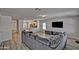 Living Room with TV, modern decor, and view into kitchen at 45322 W Sandhill Rd, Maricopa, AZ 85139