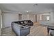 Bright living room featuring hardwood floors, a modern sofa, and an open floor plan at 45322 W Sandhill Rd, Maricopa, AZ 85139