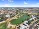 Overhead shot features a picturesque lake and golf course surrounded by homes, trees, and city skyline under a sunny sky at 4826 E Navajo Cir, Phoenix, AZ 85044