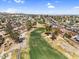 A beautiful aerial shot showcasing a golf course winding through a neighborhood with green fairways and tree-lined streets at 4826 E Navajo Cir, Phoenix, AZ 85044