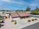 A scenic aerial view highlighting the home's well-maintained landscaping and convenient two-car garage at 4826 E Navajo Cir, Phoenix, AZ 85044