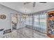 Bright dining room with large windows, chandelier lighting, and sliding glass doors to the patio at 4826 E Navajo Cir, Phoenix, AZ 85044