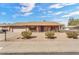 Charming single-story home with a brick facade, well-maintained gravel yard, and mature landscaping at 4826 E Navajo Cir, Phoenix, AZ 85044