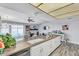 Open kitchen with white cabinetry, an island sink, and a view of the dining and living areas at 4826 E Navajo Cir, Phoenix, AZ 85044