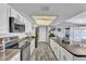 Well-lit kitchen with modern appliances, white cabinets, granite countertops, and ample counter space at 4826 E Navajo Cir, Phoenix, AZ 85044