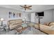 Comfortable living room featuring a ceiling fan, wood-look floors, and a comfortable seating arrangement at 4826 E Navajo Cir, Phoenix, AZ 85044