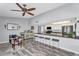 Spacious living room featuring a bar with seating, modern appliances, and neutral color palette at 4826 E Navajo Cir, Phoenix, AZ 85044