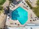 An overhead shot of a pool with lap lanes, tables with chairs, and lounge chairs at 4826 E Navajo Cir, Phoenix, AZ 85044