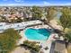 A beautiful swimming pool is surrounded by lounge chairs, tables, and lush trees, perfect for relaxation at 4826 E Navajo Cir, Phoenix, AZ 85044