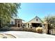 Stunning home with stone accents, a circular driveway, and unique architectural details at 5701 E Mockingbird Ln, Paradise Valley, AZ 85253