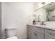 Bright bathroom featuring a modern vanity, sleek fixtures, and a large mirror at 5726 E Woodridge Dr, Scottsdale, AZ 85254