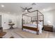 Bright bedroom featuring a four poster bed, ceiling fan and light wood-look floors at 5726 E Woodridge Dr, Scottsdale, AZ 85254