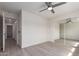 Well-lit bedroom with smooth flooring, ceiling fan and sliding mirrored closet at 5726 E Woodridge Dr, Scottsdale, AZ 85254