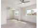 Inviting bedroom with sleek flooring, large window, ceiling fan and mirrored closet doors at 5726 E Woodridge Dr, Scottsdale, AZ 85254