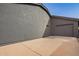 Exterior view of the house showcasing the side yard, driveway, and garage entry at 5726 E Woodridge Dr, Scottsdale, AZ 85254