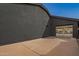 Exterior view of the home showing a side-entry garage and freshly painted stucco at 5726 E Woodridge Dr, Scottsdale, AZ 85254